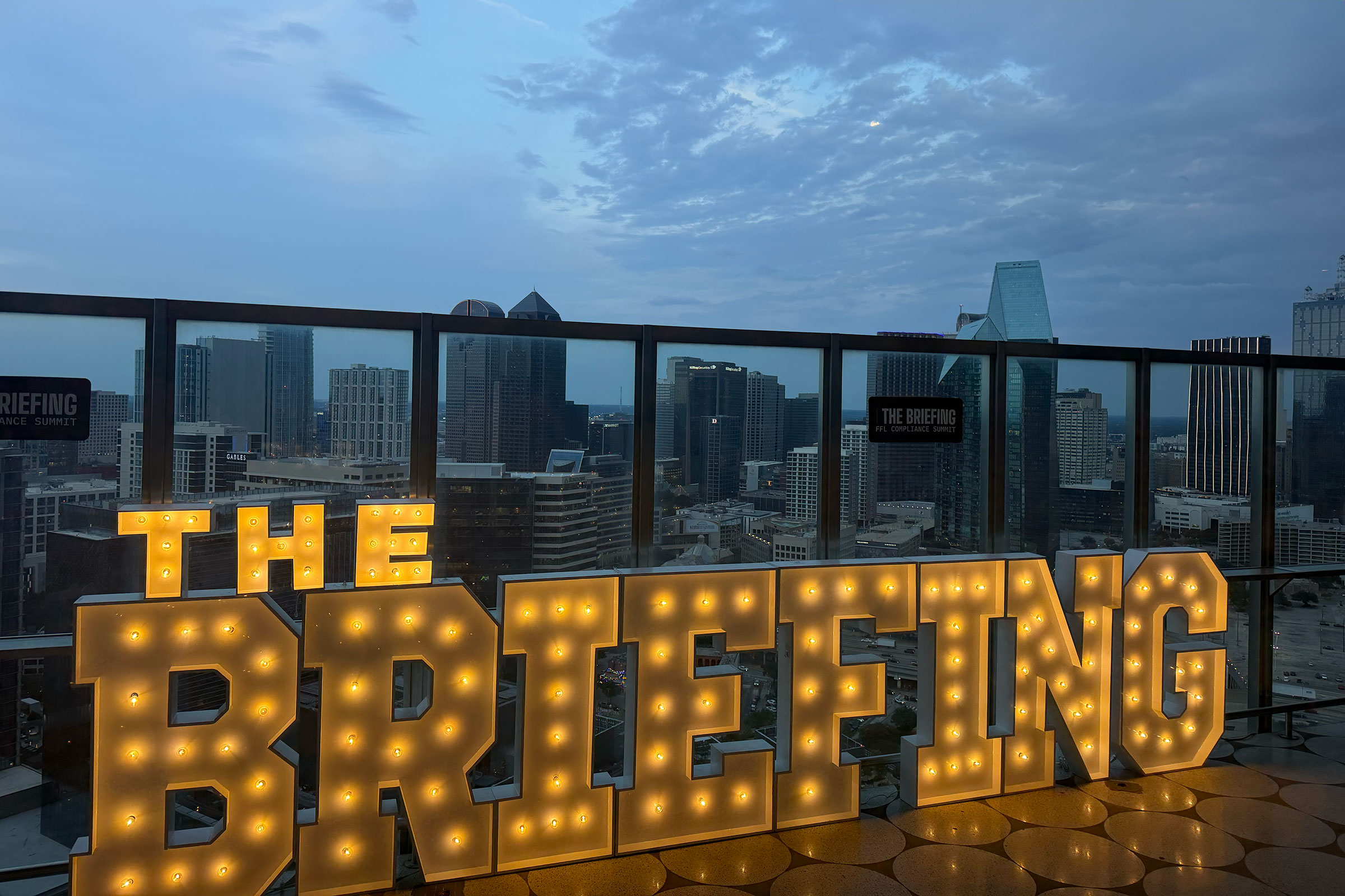 The lit “THE BRIEFING” marquee at night