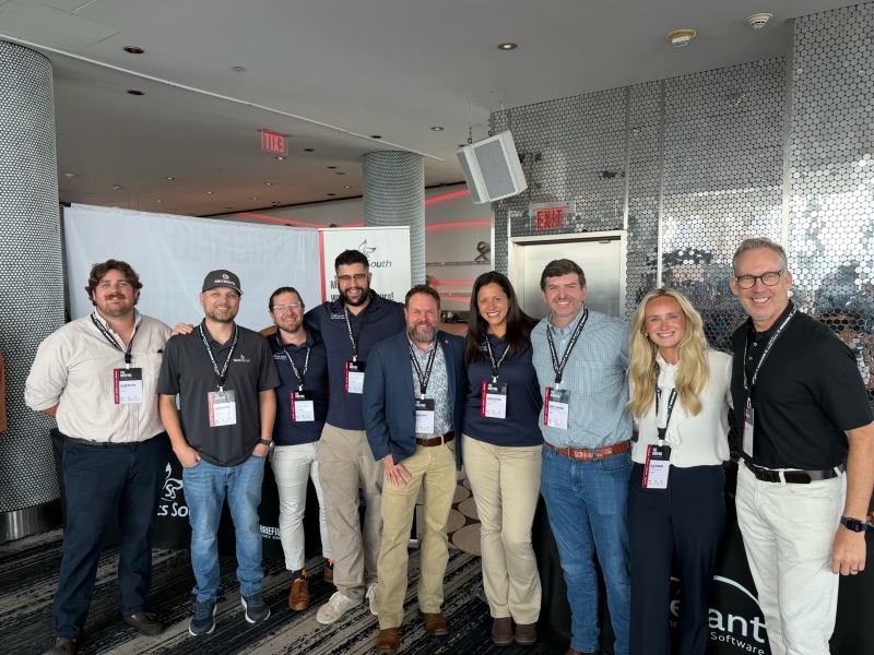 Sponsor teams posing together at the Sports South and Celerant booths