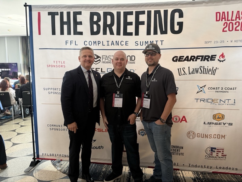 Three men standing in front of The Briefing backdrop