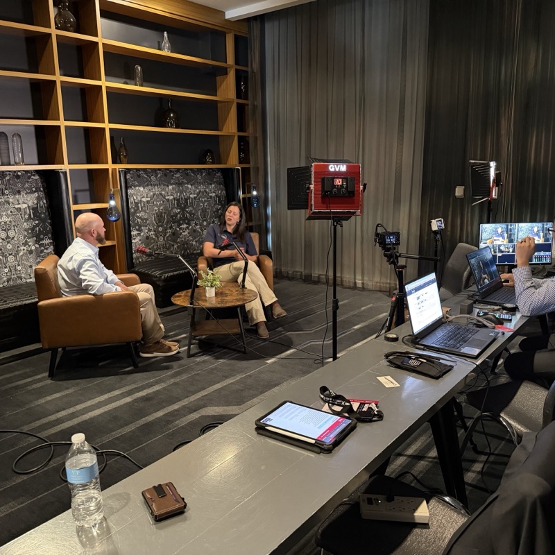 Celerant Chief Growth Officer Michele Salerno being interviewed on the livestream set, with studio lighting and a production desk in the foreground