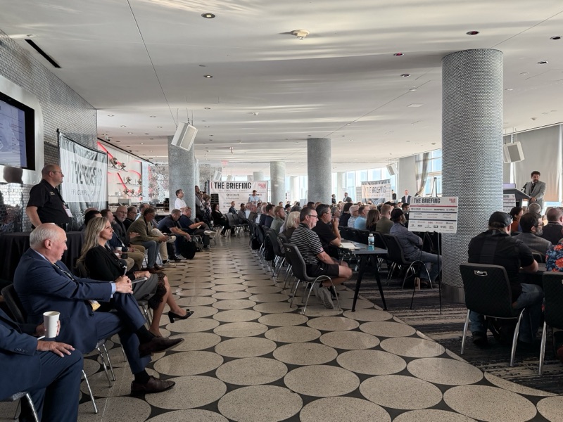 Attendees seated and listening during a session
